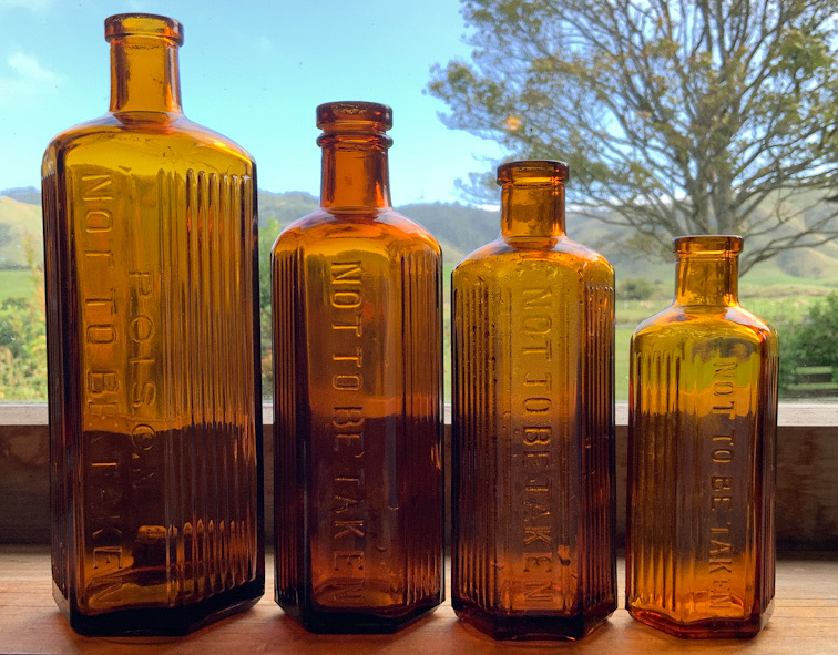 Four vintage Brown Glass Poison bottles